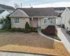 Ranch-style home featuring central air condition unit and a front lawn