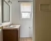 Kitchen with white stove, light tile patterned floors, and range hood