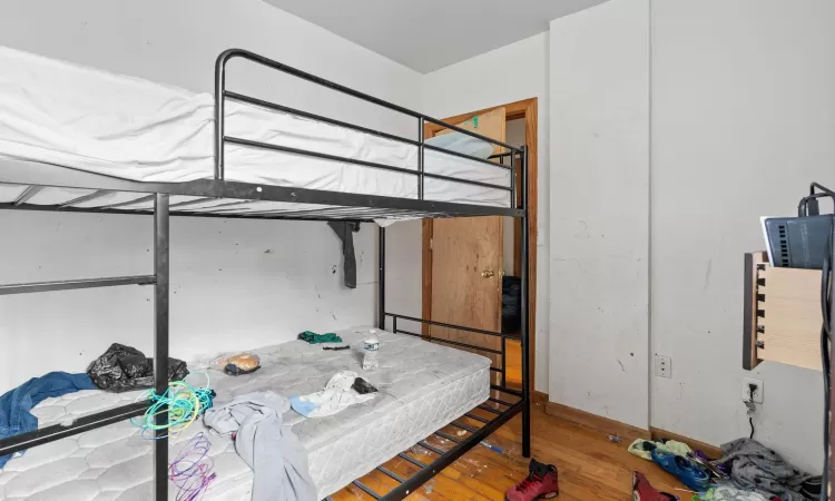 Bedroom featuring wood-type flooring