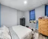 Bedroom with a paneled ceiling, hardwood / wood-style flooring, and cooling unit