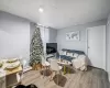 Living room featuring hardwood / wood-style floors, a paneled ceiling, and a baseboard radiator