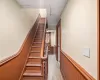 Staircase featuring wooden walls and hardwood / wood-style floors