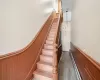 Stairs with wood-type flooring and a baseboard radiator