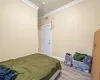 Bedroom with wood-type flooring and ornamental molding