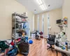 Office area with hardwood / wood-style flooring and a baseboard heating unit