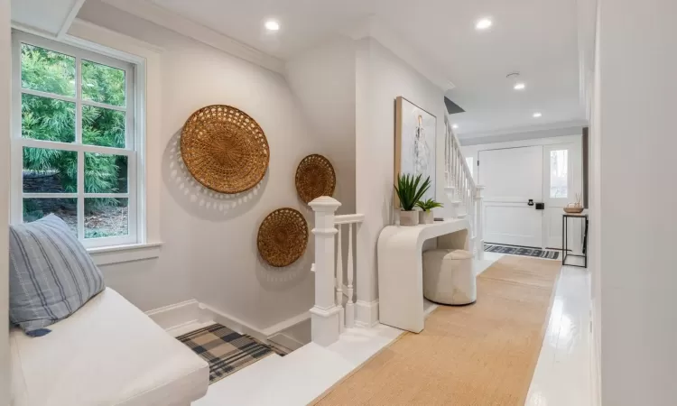 Corridor with crown molding and hardwood / wood-style flooring