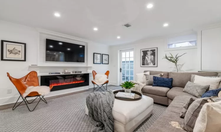 Carpeted living room featuring crown molding