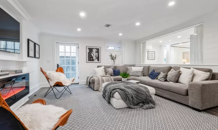 Living room featuring crown molding and wood-type flooring