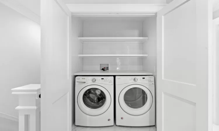 Washroom with washing machine and dryer and ornamental molding