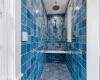 Bathroom with tile patterned flooring, a tile shower, and tile walls