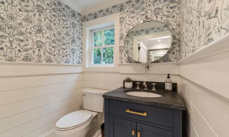 Bathroom with vanity, ornamental molding, and toilet