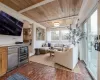 Living room featuring wooden ceiling and beverage cooler