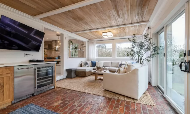 Living room featuring wooden ceiling and beverage cooler