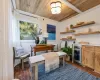 Living area with crown molding, wine cooler, wooden ceiling, and wood walls