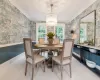 Dining area featuring ornamental molding and a notable chandelier