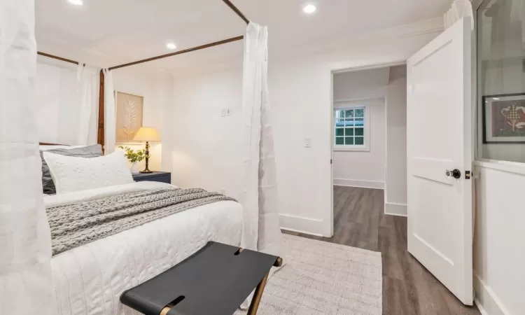 Bedroom featuring dark hardwood / wood-style flooring and ornamental molding