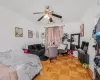 Bedroom featuring ceiling fan and parquet floors