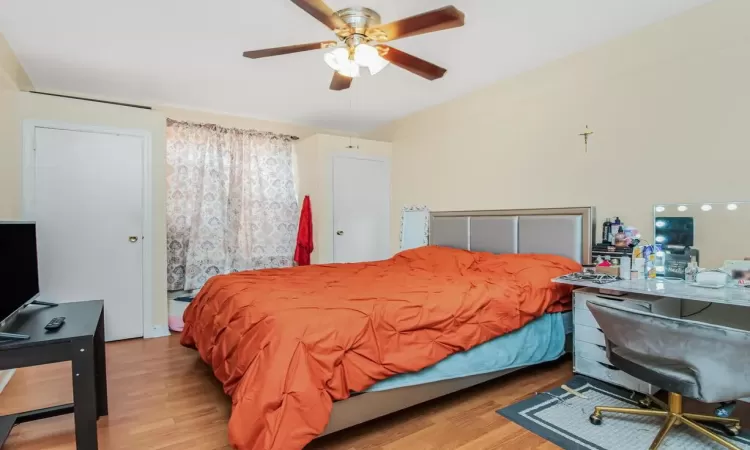 Bedroom with ceiling fan and light hardwood / wood-style floors