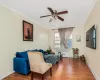 Sitting room with radiator heating unit, hardwood / wood-style flooring, and ornamental molding