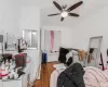 Bedroom with radiator, ceiling fan, and dark hardwood / wood-style floors