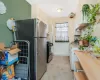 Kitchen with stainless steel appliances, white cabinetry, and sink