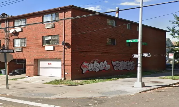 View of building exterior featuring a garage