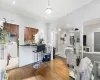 Kitchen with white fridge, ornamental molding, dark wood-type flooring, and tasteful backsplash