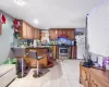 Kitchen with backsplash, light tile patterned flooring, and stainless steel appliances