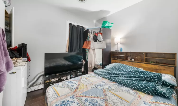 Bedroom featuring dark hardwood / wood-style floors and a baseboard radiator