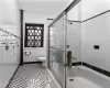 Bathroom with toilet and tile walls