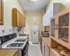 Kitchen with sink, tasteful backsplash, white fridge, black range with gas cooktop, and a textured ceiling