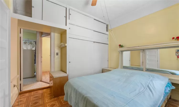 Bedroom featuring ceiling fan and a closet