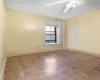 Spare room featuring ceiling fan and light parquet flooring