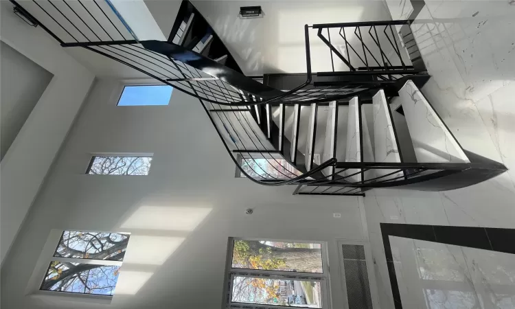 Stairway with a towering ceiling