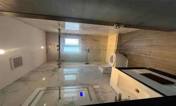 Bathroom featuring vanity, a shower with shower door, tile walls, and toilet