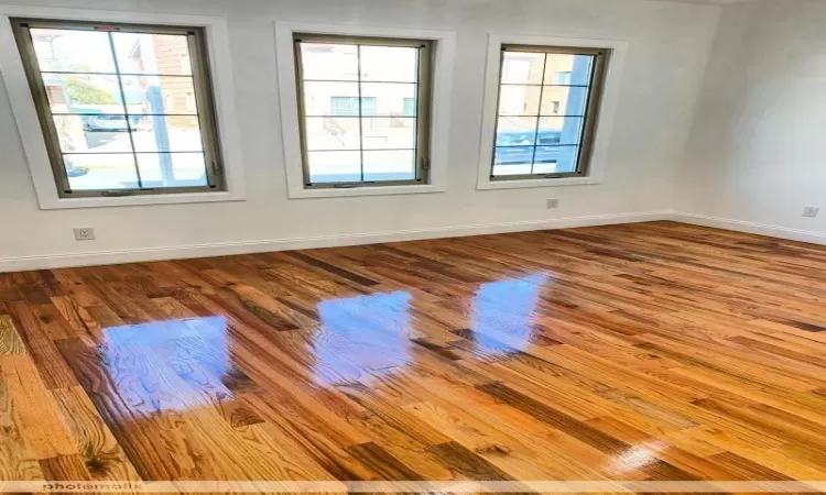 Empty room with light hardwood / wood-style flooring