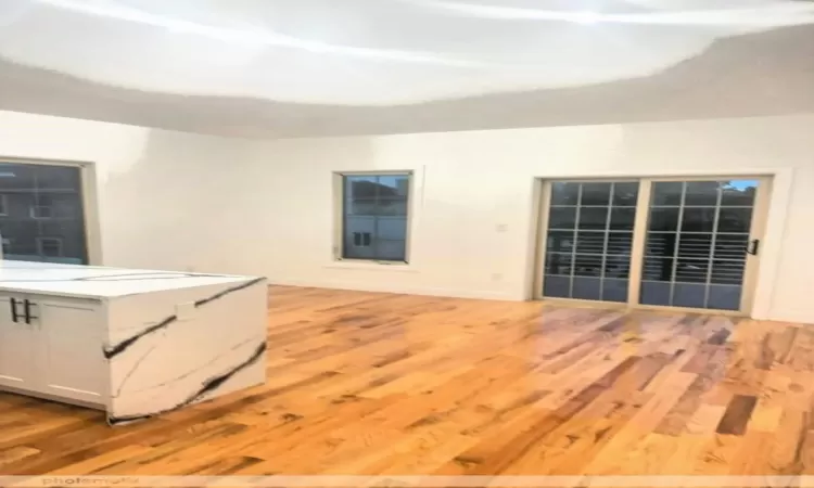 Unfurnished living room with light wood-type flooring