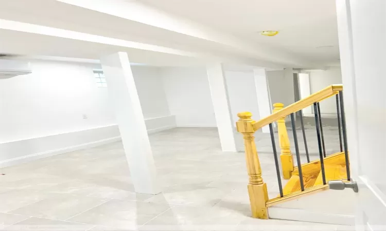 Staircase with tile patterned flooring and a wall unit AC