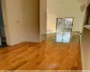 Spare room featuring lofted ceiling, a wall unit AC, and light hardwood / wood-style flooring