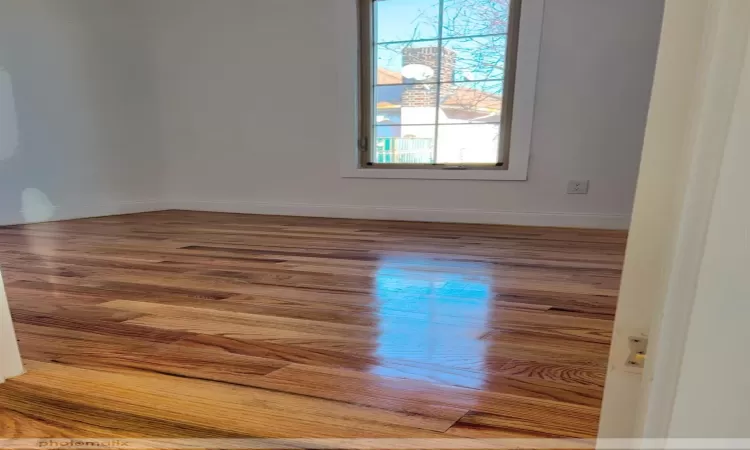 Spare room featuring hardwood / wood-style floors