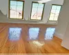 Spare room featuring a healthy amount of sunlight and light hardwood / wood-style floors