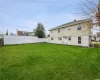 Rear view of house with a lawn