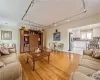 Living room featuring sink, light hardwood / wood-style floors, track lighting, and ornamental molding