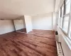 Spare room featuring dark hardwood / wood-style flooring and plenty of natural light