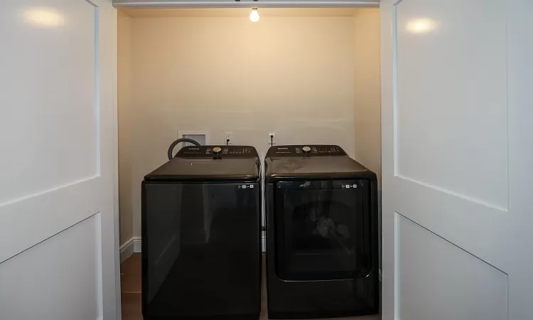 Clothes washing area featuring independent washer and dryer