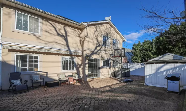 Back of property featuring a patio area and an outdoor structure