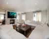 Living room with a healthy amount of sunlight, wood-type flooring, and crown molding