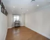 Unfurnished room with hardwood / wood-style floors and crown molding