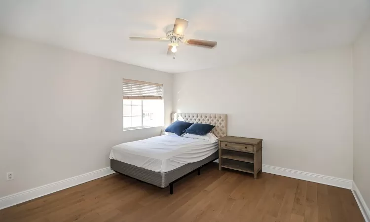 Bedroom with hardwood / wood-style flooring and ceiling fan