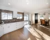 Kitchen with crown molding, pendant lighting, decorative backsplash, white cabinets, and hardwood / wood-style flooring